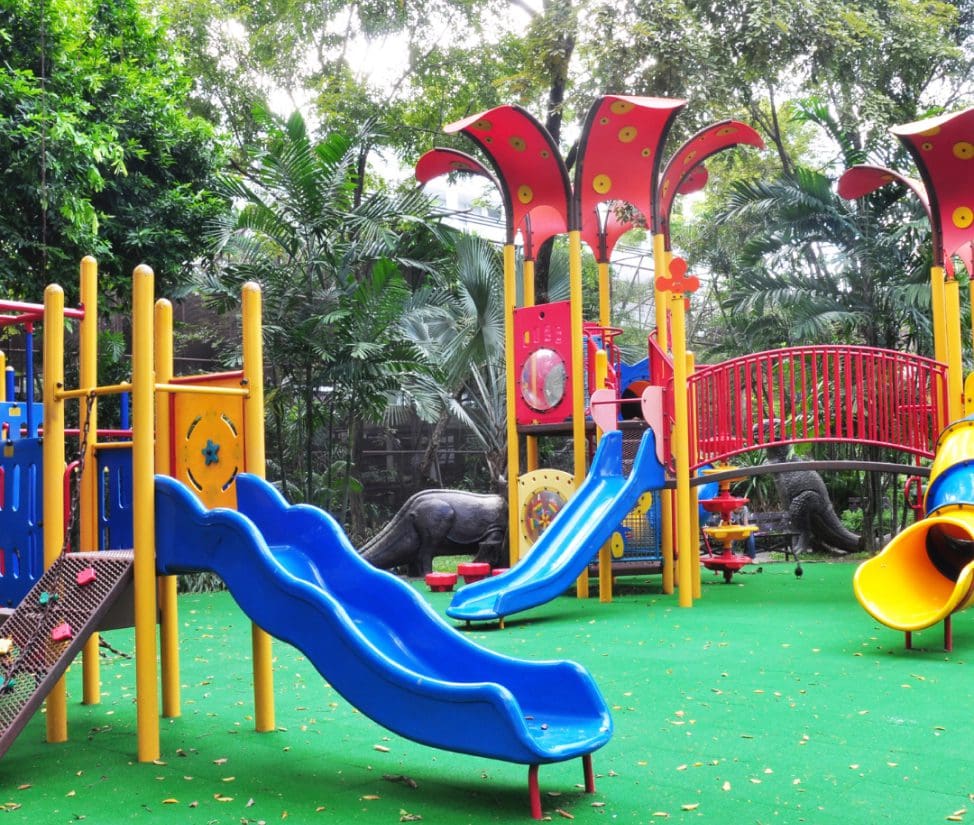Safety-certified playground equipment by Impact Playgrounds with soft fall zones.